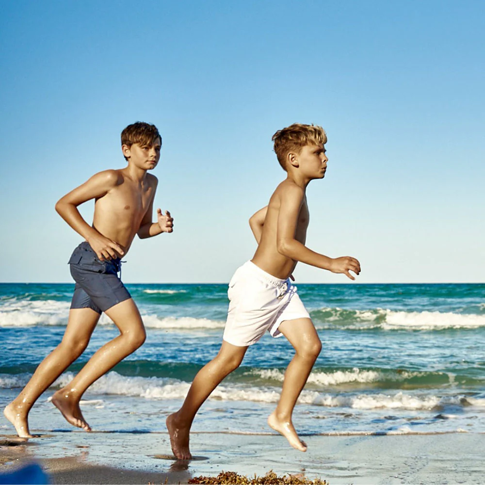 Family Dressing -Family Dressing two boys running on beach